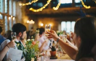 A group of people toasting with champagne glasses | Carofin